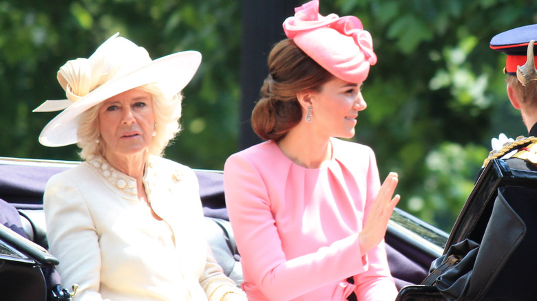 Camilla Parker Bowles and Kate Middleton riding in a carriage