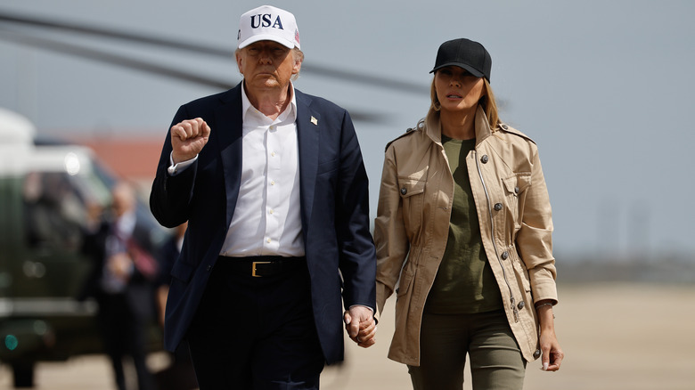 Donald and Melania Trump pictured holding hands.