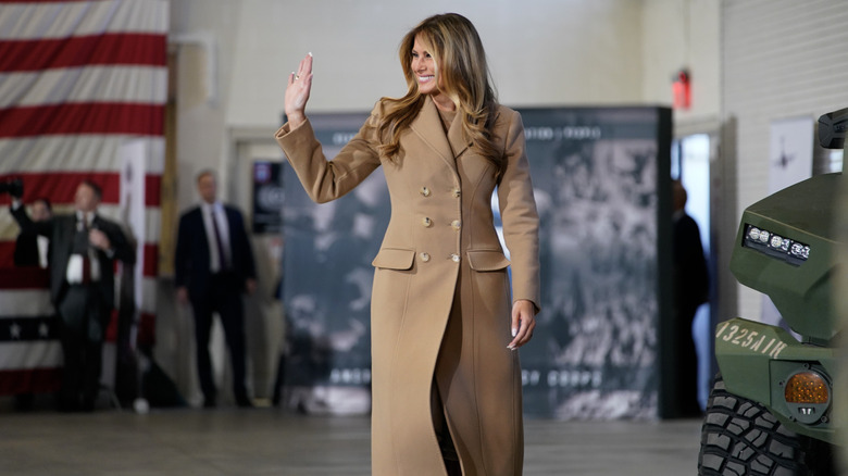 Melania Trump wearing a tan coat