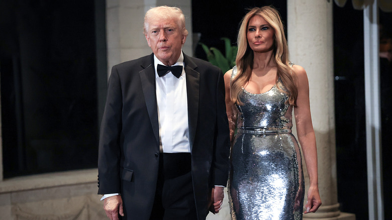 Donald Trump looking bored in a tuxedo while Melania looks perturbed in shiny dress