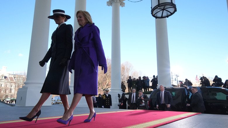First ladies Jill Biden and Melania Trump walk a red carpet on Jan. 20, 2025