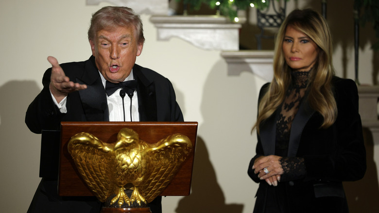 President Donald Trump delivering remarks as First Lady Melania Trump looks on during the Congressional Ball at the Grand Foyer of the White House