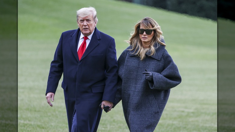 Donald and Melania Trump holding hands
