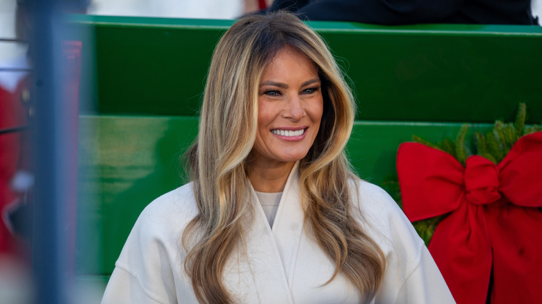 Melania Trump wearing a white coat