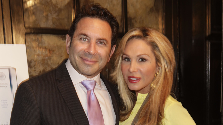 Paul Nassif black suit Adrienne Maloof yellow top