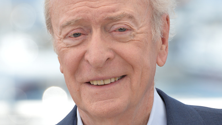 Michael Caine smiling and wearing a suit