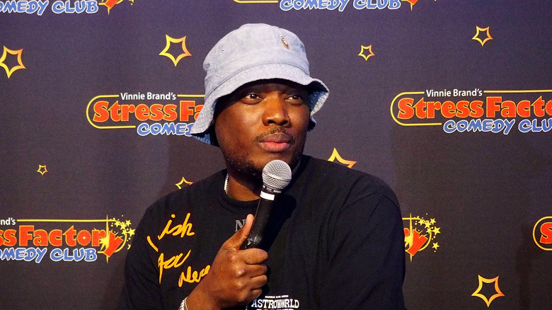 Michael Che, performing in 2020, looking upset