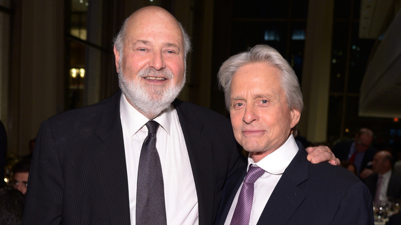 Rob Reiner posing with his arm around Kirk Douglas