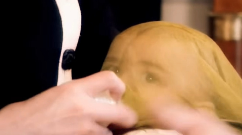 Michael Jackson feeds Blanket (Bigi) during an interview with Martin Bashir