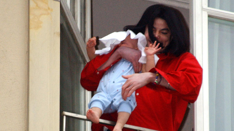 Michael Jackson dangles son Blanket (Bigi) over a balcony railing