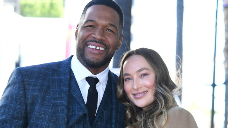 Michael Strahan and Kayla Quick posing for a photo.