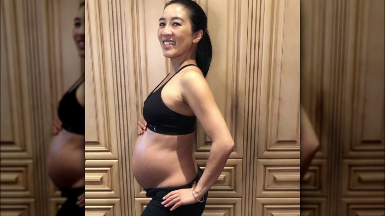 Michelle Kwan showing her pregnant stomach