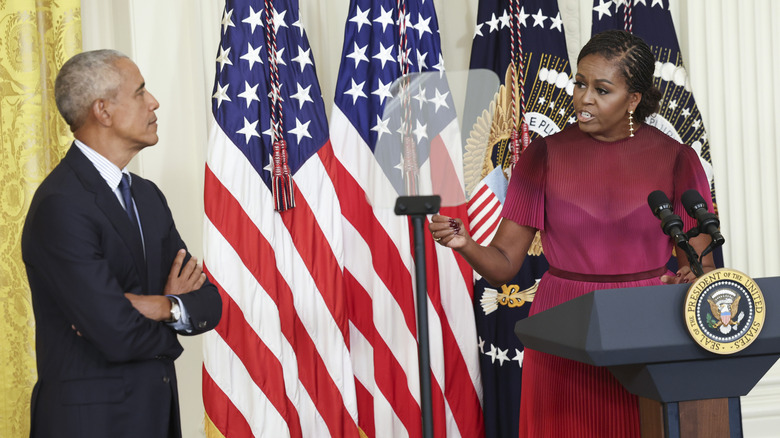 Barack Obama listening to Michelle Obama