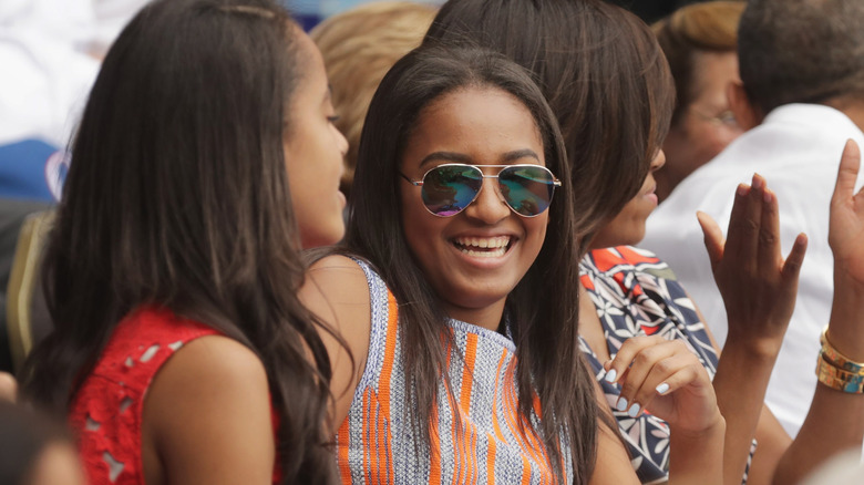 Sasha Obama smiling in sunglasses