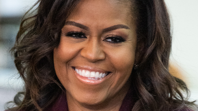 Michelle Obama smiles at an event