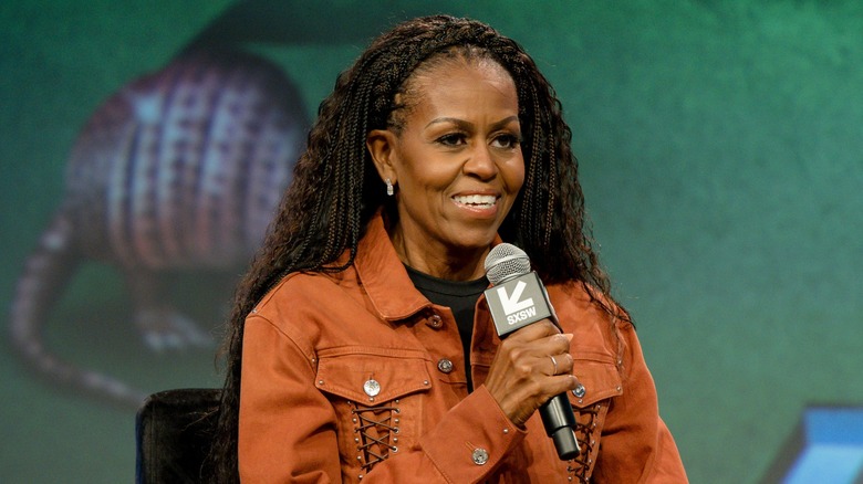 Michelle Obama speaking into a microphone at SXSW 2025