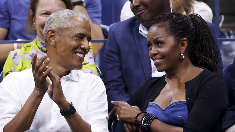Michelle and Barack Obama smiling at each other