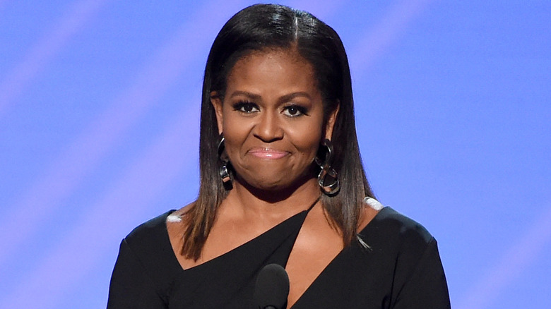 Michelle Obama looking close to tears as she stands on stage