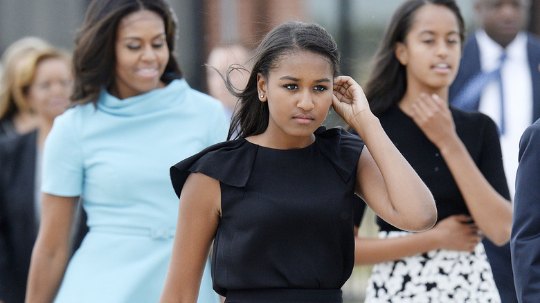 Michelle Obama, Sasha Obama, and Malia Obama walking