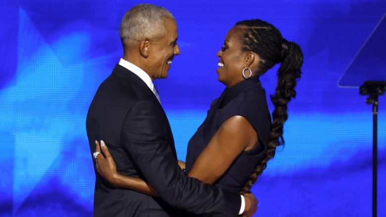 Barack Obama and Michelle Obama embrace on stage at the Democratic National Convention in Chicago, IL (2024)