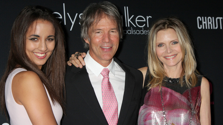 Claudia Rose Kelley turning to the side and smiling beside parents David E. Kelley and Michelle Pfeiffer