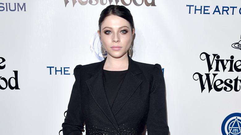 Michelle Trachtenberg wearing posing in a black outfit at an event