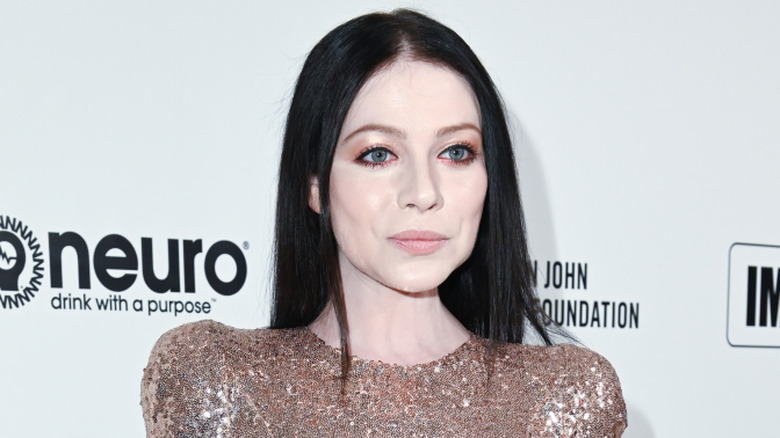 Michelle Trachtenberg poses in sparkly dress with long black hair
