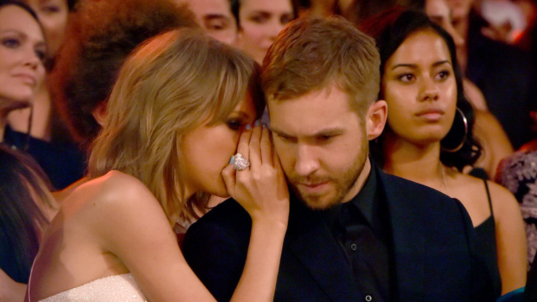 Taylor Swift whispering to Calvin Harris