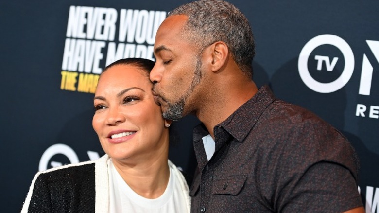 Mike Jackson kisses Egypt Sherrod on the cheek at the Regal Atlantic Station in Atlanta, GA (2022)