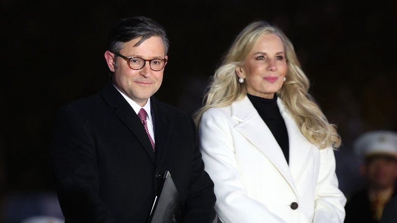 Mike Johnson and wife Kelly smiling while wearing coats outside