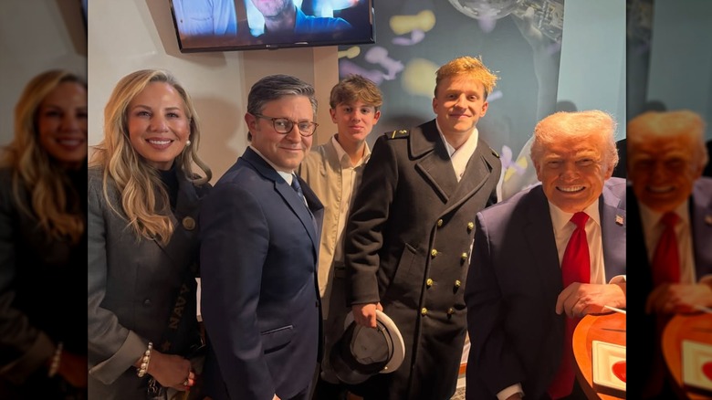 Mike and Kelly Johnson posing with kids and Donald Trump