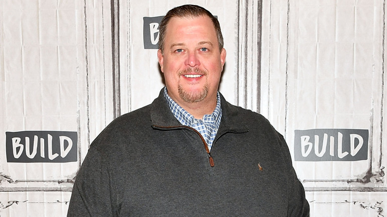 Billy Gardell poses in a quarter-zip in 2017