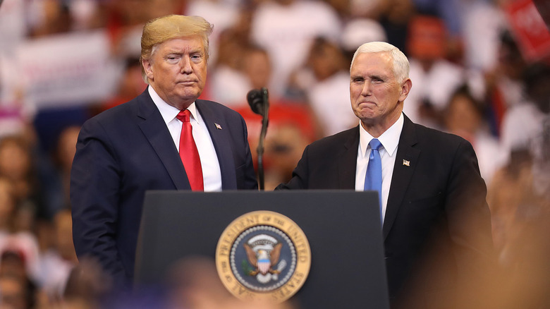 Donald Trump and Mike Pence stand together during a homecoming campaign rally