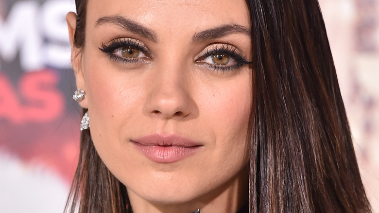 Mila Kunis poses at event 