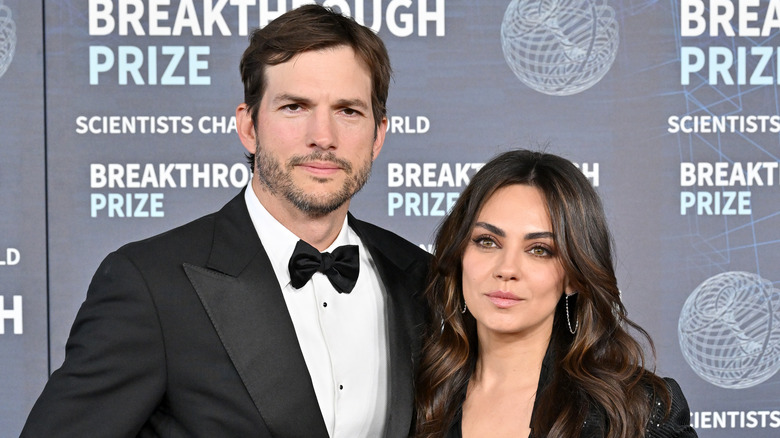 Mila Kunis posing with Ashton Kutcher