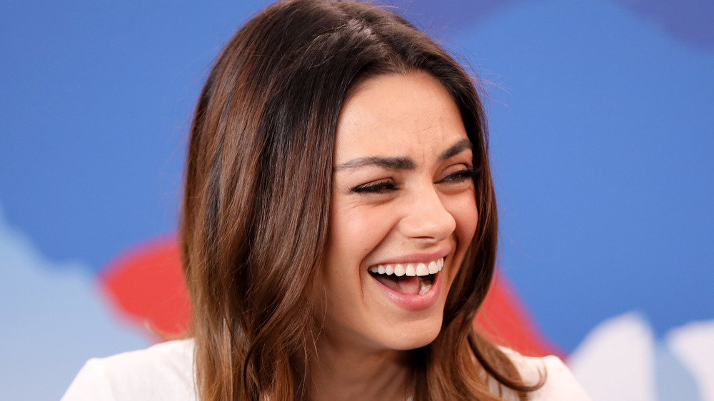 Mila Kunis laughing