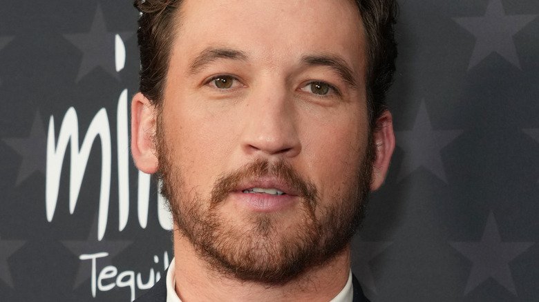 Miles Teller poses in a tux