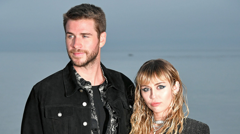 Miley Cyrus and Liam Hemsworth on a beach