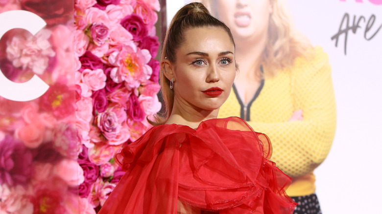 Miley Cyrus posing at a movie premiere