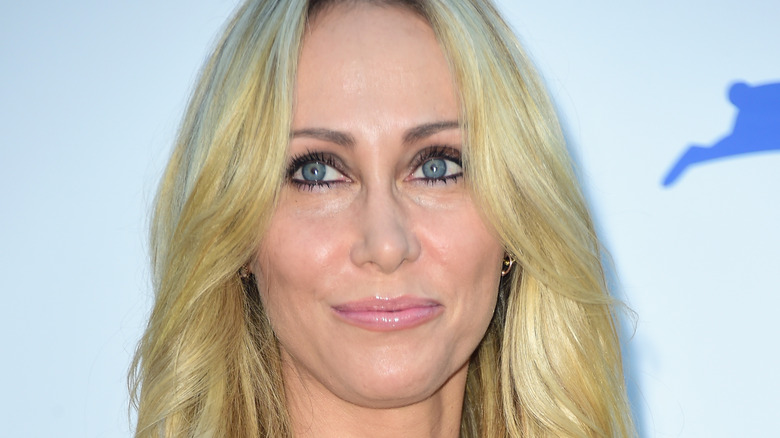 Tish Cyrus smiling and looking up