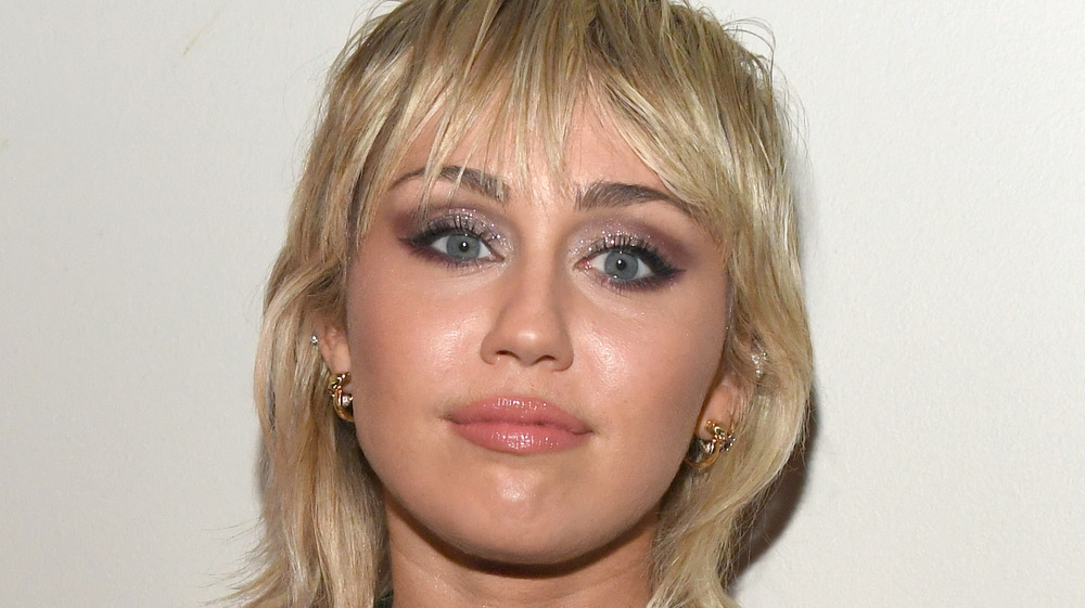 Miley Cyrus with a neutral expression
