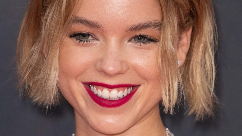 Milly Alcock smiling short blonde hair 