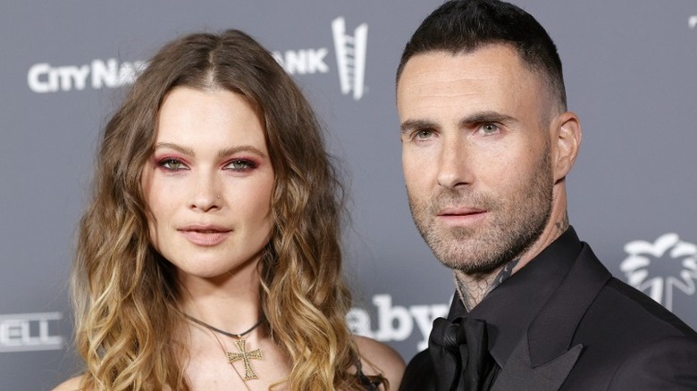 Behati Prinsloo and Adam Levine posing
