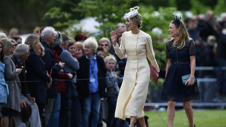 Royal wedding onlookers standing in a group