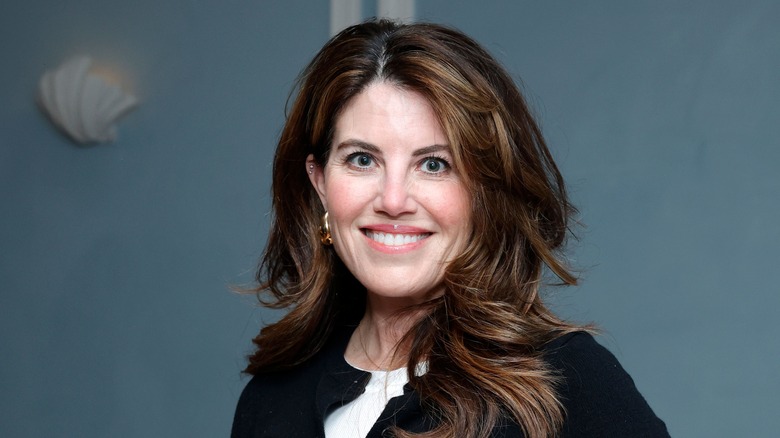 Monica Lewinsky posing in front of a blue background