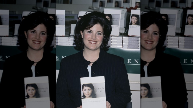Monica Lewinsy displaying copy of her book, Monica's Story
