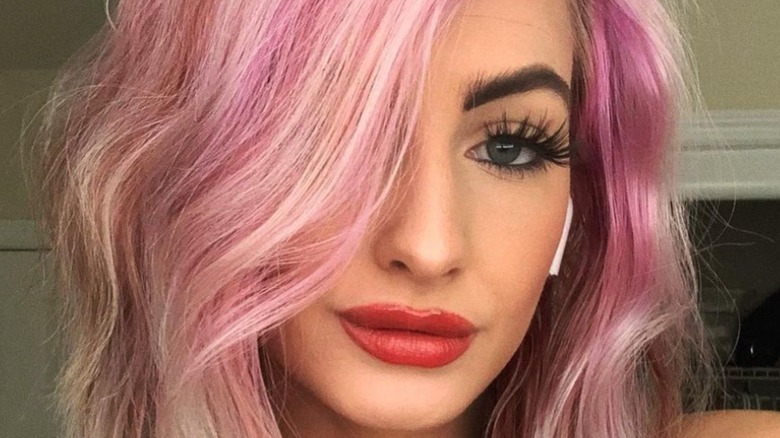 Moriah Plath smiles pink hair selfie red lipstick