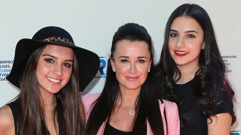 Kyle Richards posing with two of her kids