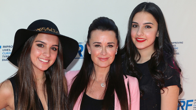 Kyle Richards posing with two of her kids