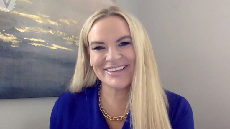 Heather Gay smiling with an airpod in